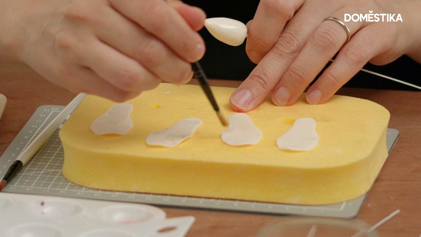 She paints one side of the petals and the bud with egg white