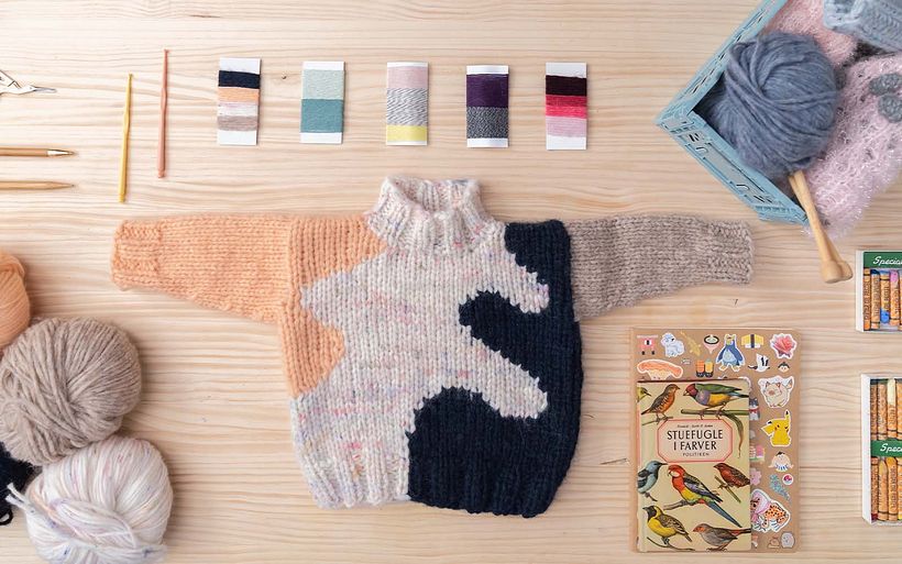 A miniature version of the sweater allows Laura to demonstrate how this pattern fits together.