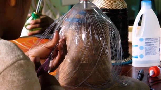 Chaque fabricant collecte des bouteilles en plastique, les coupe en bandes et crée une chaîne.