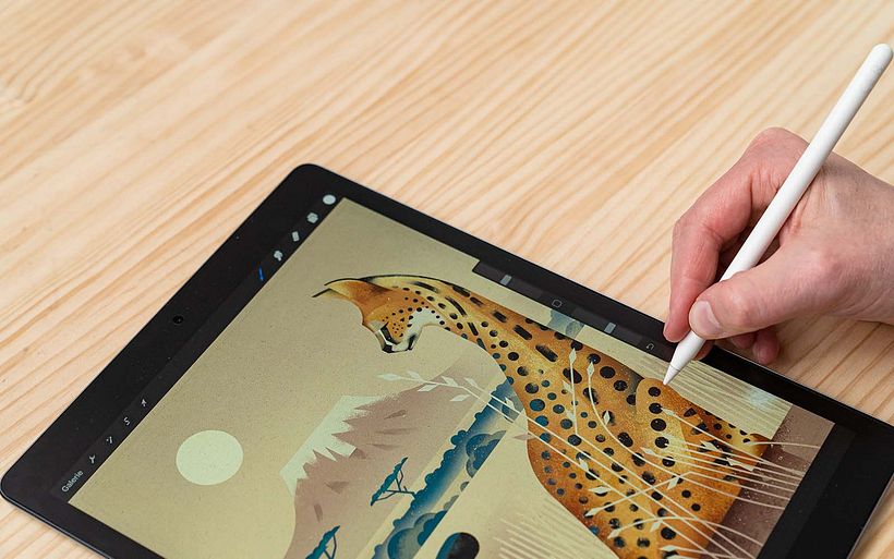 Dieter adds details to a page from a children's book project.