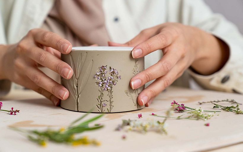 Pressing flowers into her designs allows Hessa to add an organic feel to her ceramics.