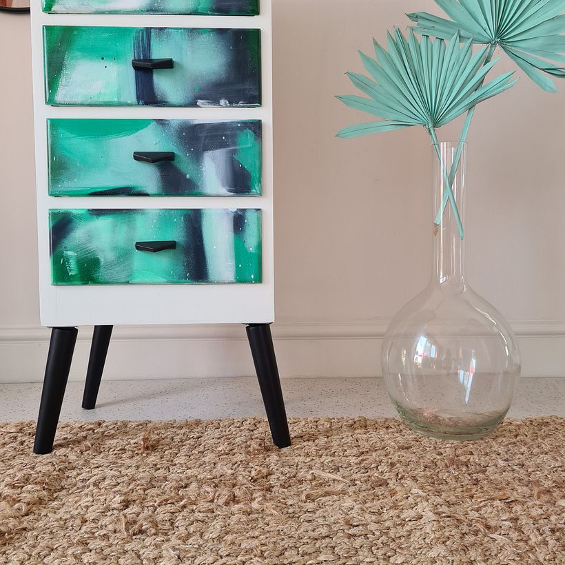 Staged using a rug in the foreground, and spray painted foliage.