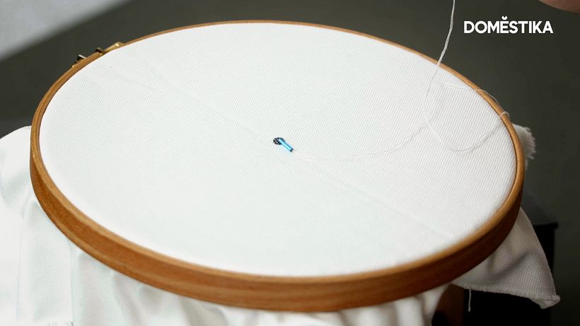 Starting your embellishment at the center of your embroidery hoop allows the most space for expanding your embellishment.