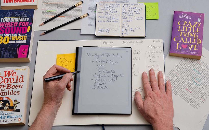 Tom takes notes while teaching his Domestika course on life writing.