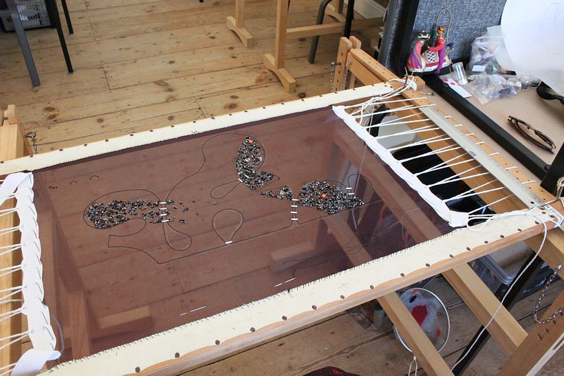 Each piece is worked separately on a frame, the pattern piece for the top transferred and the embellishment done if necessary