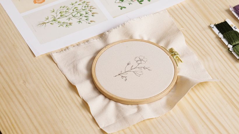 Set up your fabric in the embroidery hoop, and use a Frixion pen to transfer your design to the fabric.