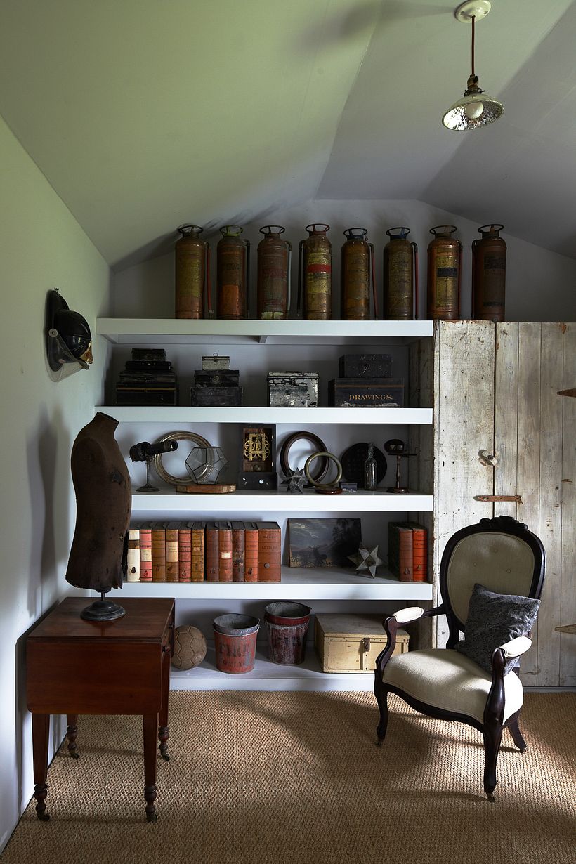 Collections displayed on shelves built in around an antique cupboard.
