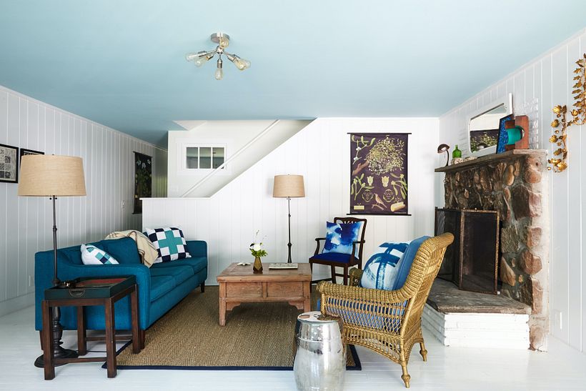 An aqua painted ceiling helps to lighten a low ceiling living room.