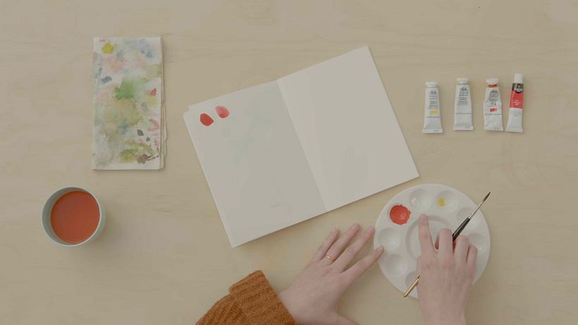 Emma creates a vibrant peachy pink by combining red, white, and yellow pigments.