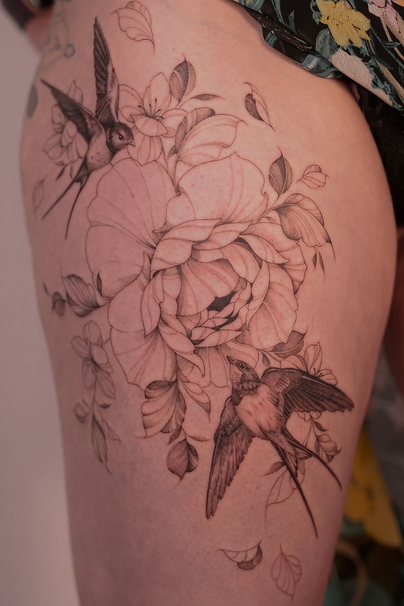 Flower with swallows on a thigh 1