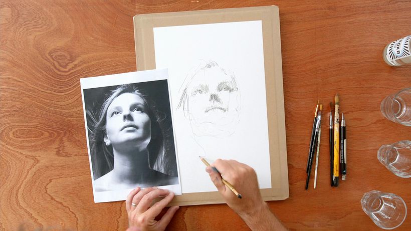 Sketch out the face shape and shadows in graphite first.