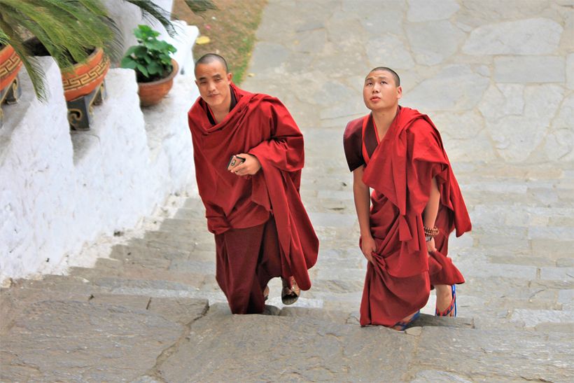Buddhist monasticism is omnipresent in Bhutanese people daily lives. Here, two monks head upstairs to chant their prayers.