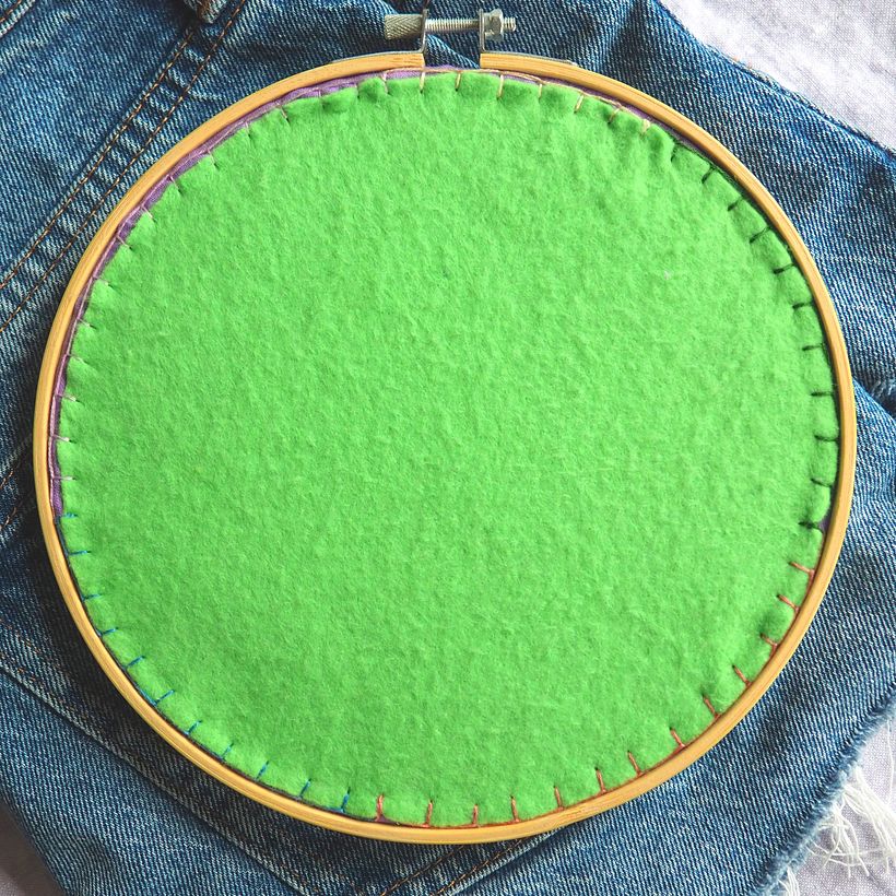 I've backed my hoop with wool felt. I've used leftover threads to create a rainbow on the back