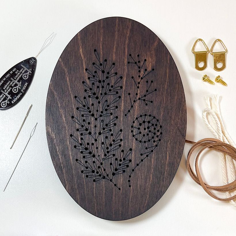 Laser engraved design on to stained panel surrounded by kit elements.