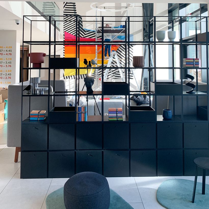 Nicolas Lawin taping a mural