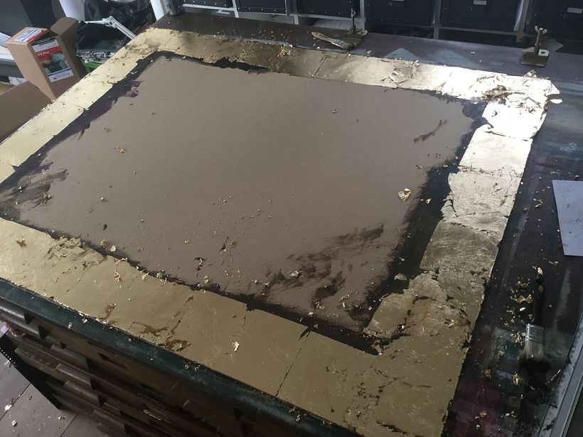 The backing board was gilded, stained and the screen printed over