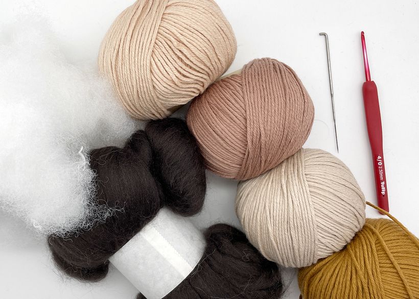 Materials needed to create an amigurumi doll.
