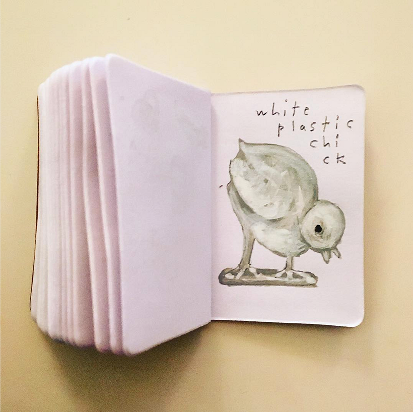 White plastic chick on a stand