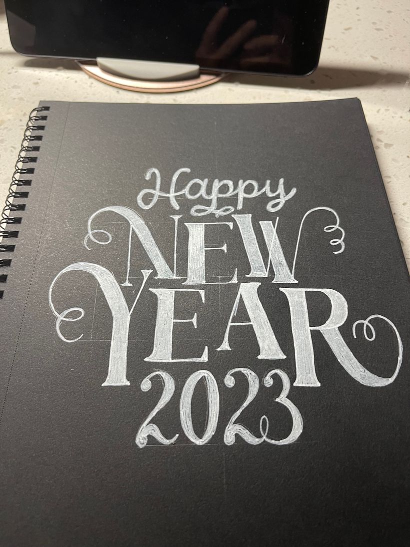 Ultimately I ended up sketching and inking the second layout, with staggered (tipsy?)baselines for "New Year".