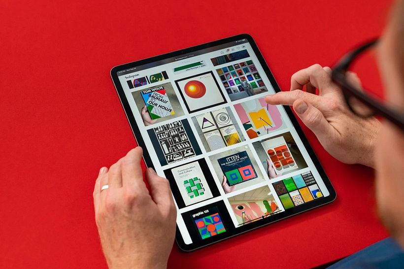 Designer Julian Montague looking at different examples of graphic design.