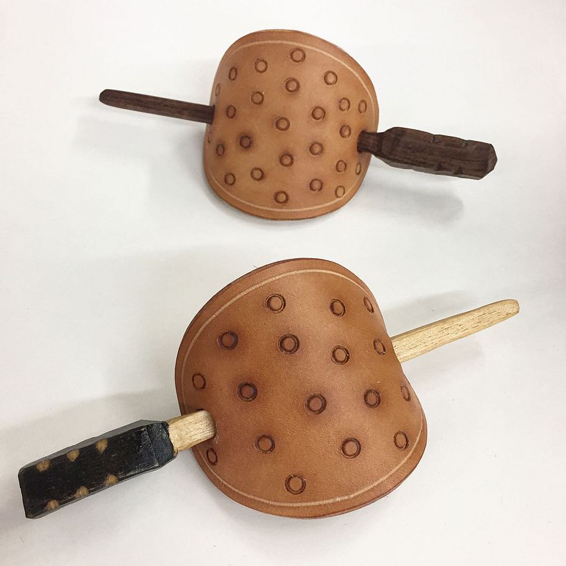 These hair barrettes were made with leather scraps and hand-carved wood hair pins