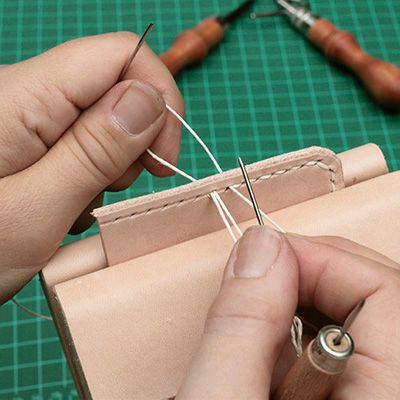Sewing the vegetable tanned cowhide by hand with a saddle stitch