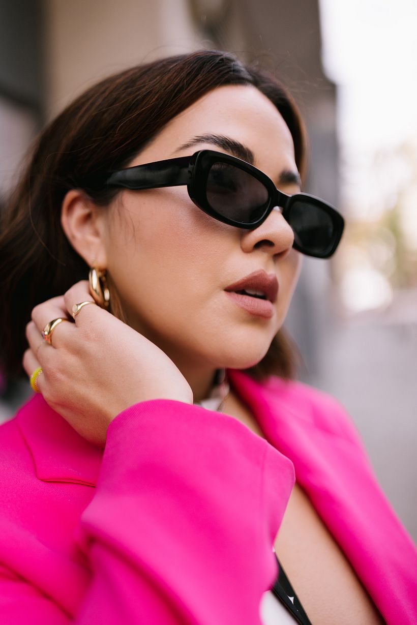 Accessory shot of the sunglasses and some of her hand jewelry.