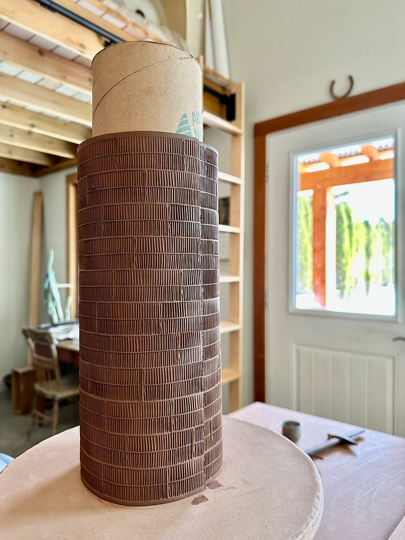 forming the large slab into a cylinder around a form