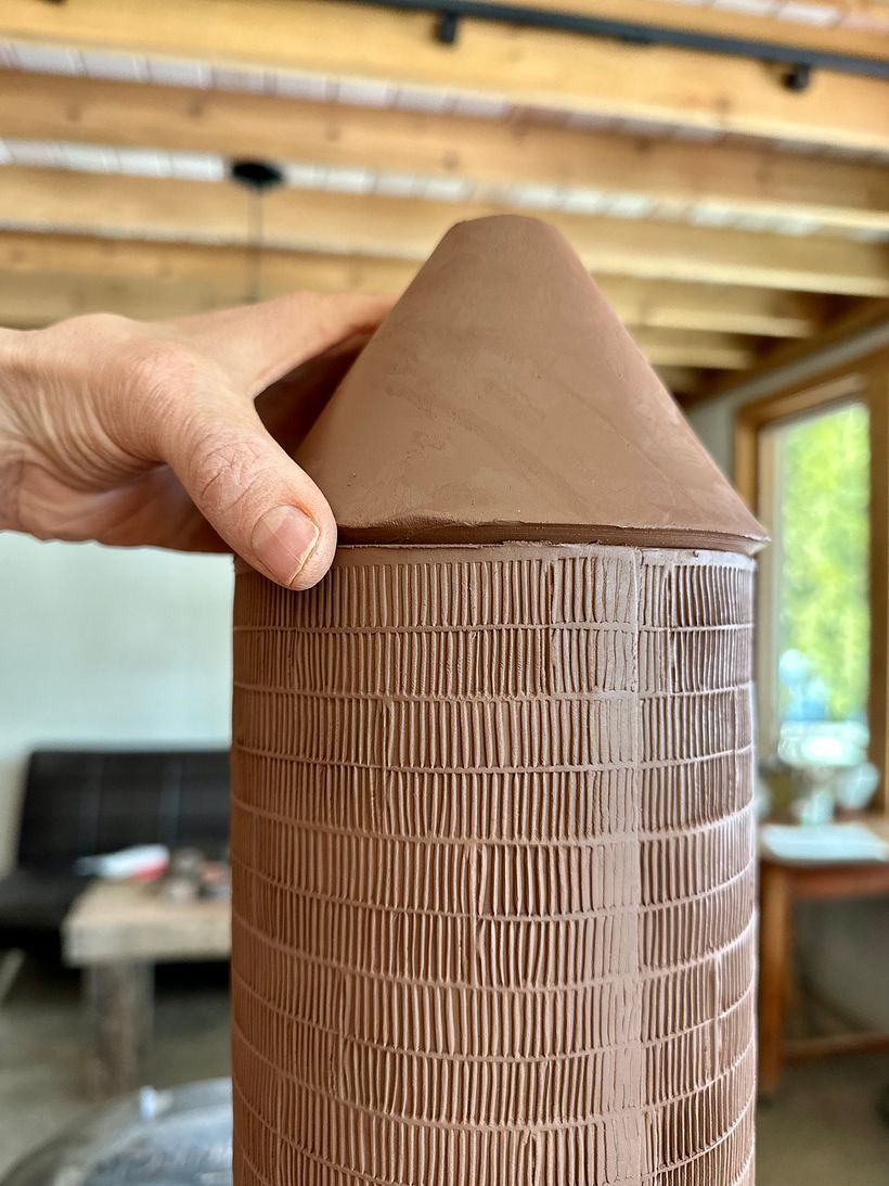 joining the cone to the large cylinder