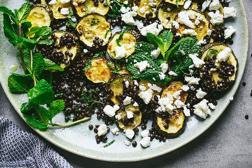 Salad of roasted zucchini and black lentils with feta cheese and mint