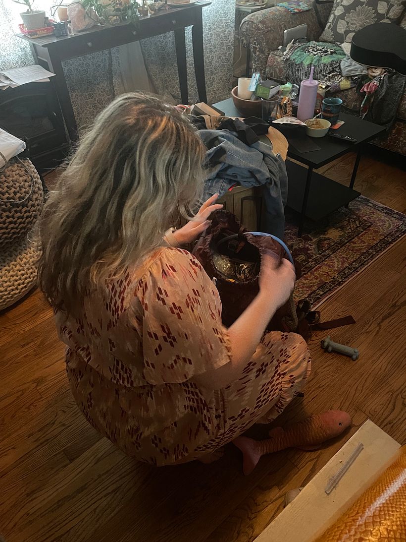 Reference Photo of me in my living room, packing my bag.