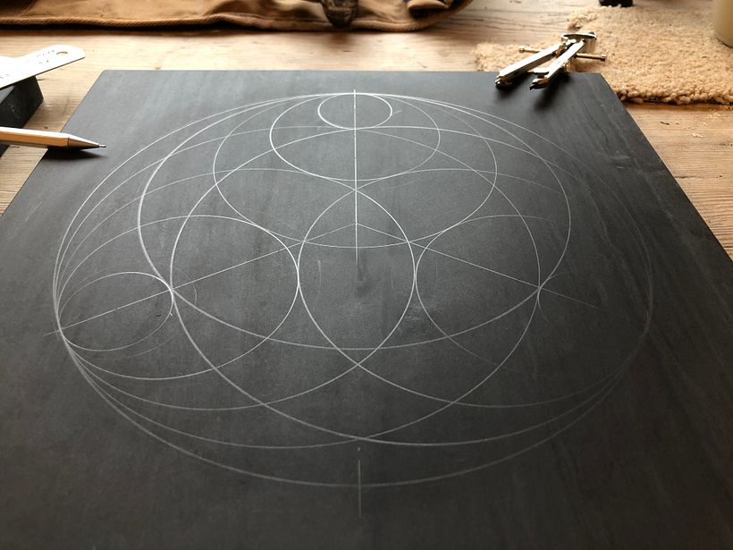 Marking the geometric pattern out in pencil on slate. 