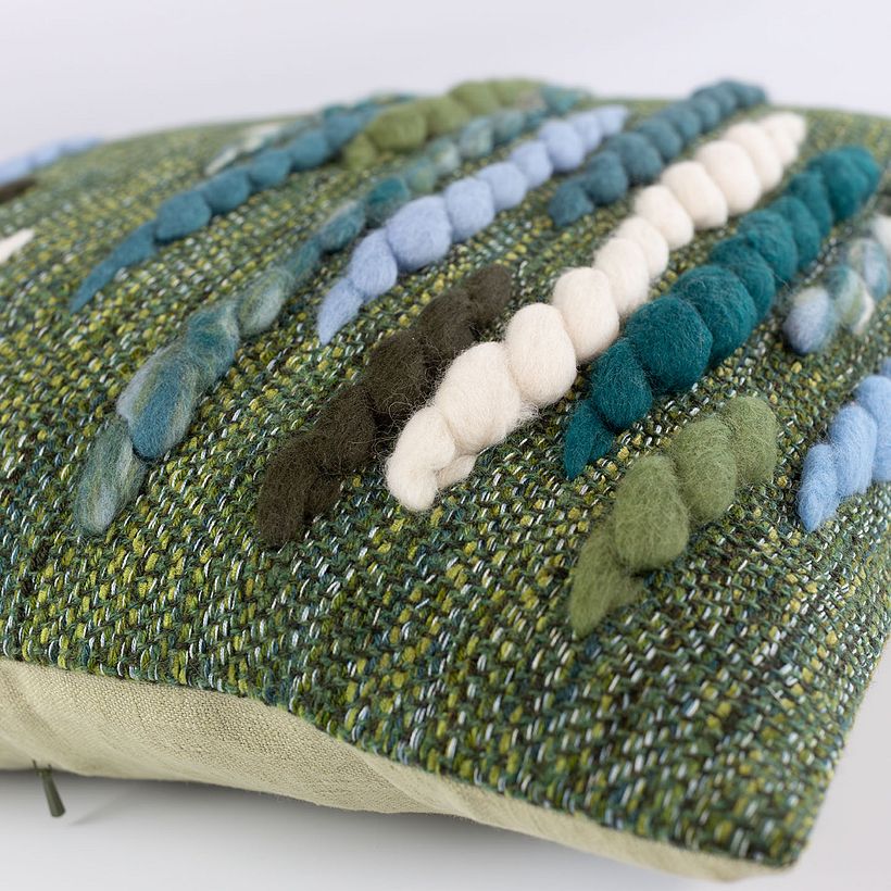 Detail shot of the unique blend of yarns and wool roving on the cushion.