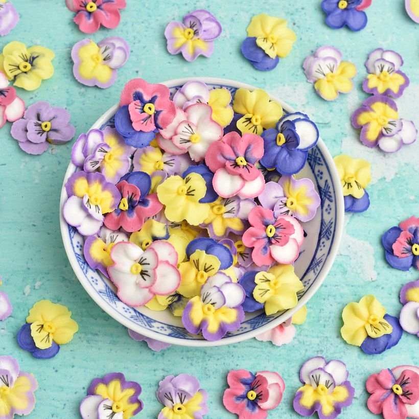 Hand-piped royal icing pansy flowers.