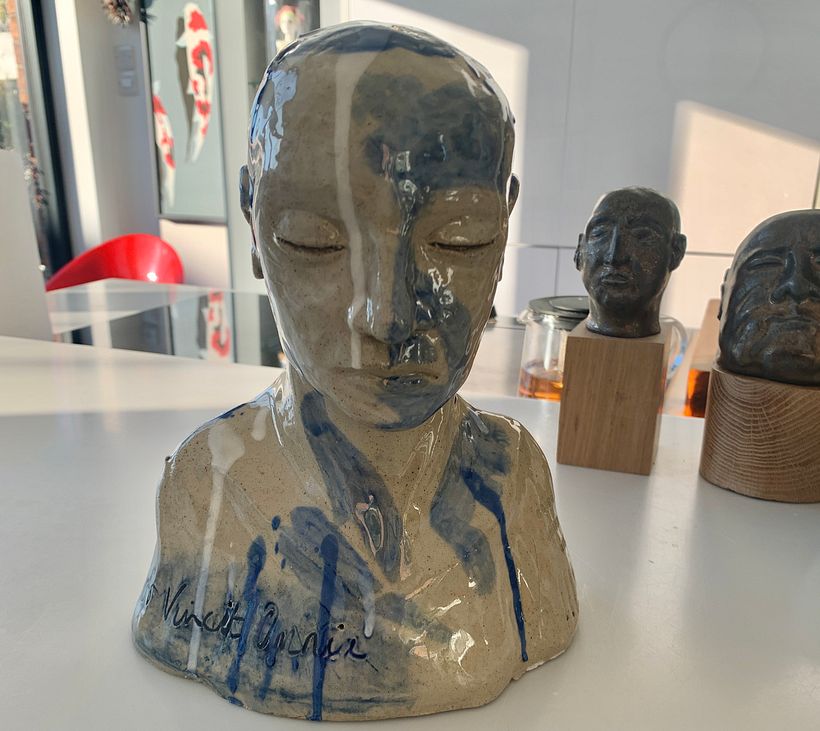 My sculpture standing in front of two of my previous attempts at figurative ceramics