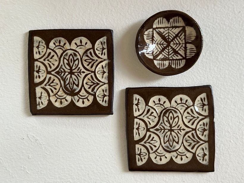 Tiles and ring holder in Chocolate clay and Dover slip using the Mishima technique. I used ceramic stamps that I made. 