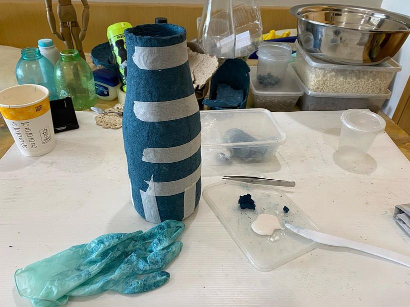 Putting them back with some glue and pulp. And masking tape.