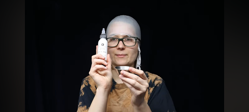 Getting bald cap in place.