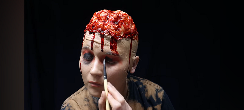 Adding eye makeup.