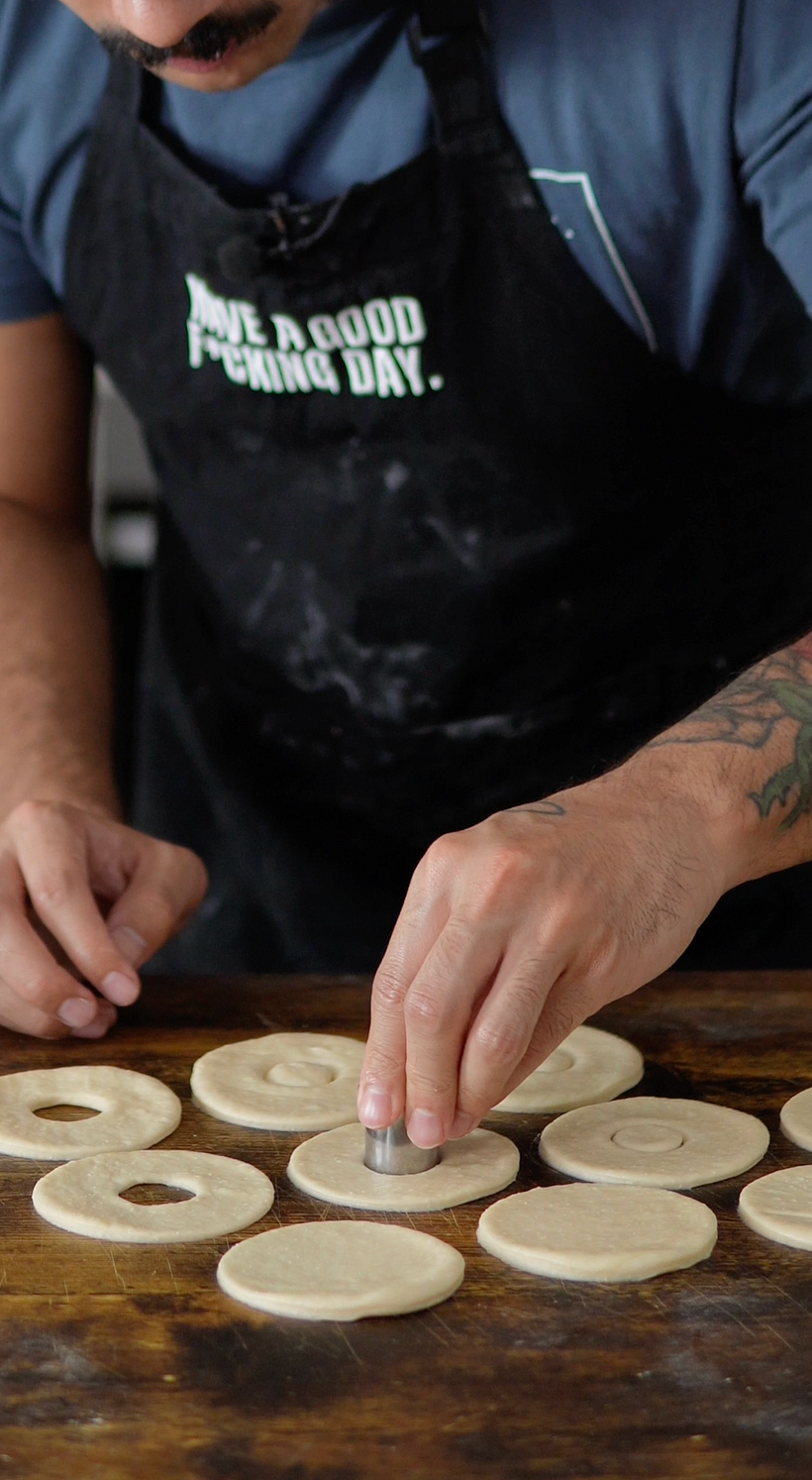 Cutting out the middle pieces. Those are our mini donuts.