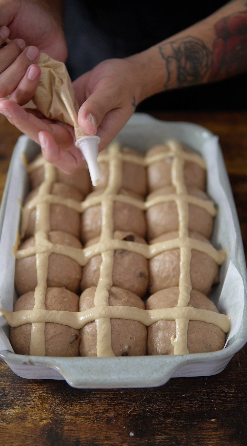 Adding the crosses, then into the oven.