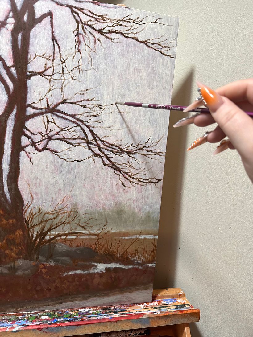 Going back in with a much smaller brush to paint in our smaller branches and twigs. Constantly checking our reference!