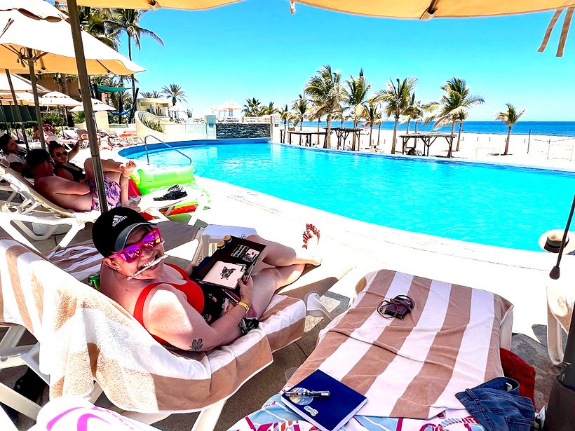 Bonus picture of me painting by the pool, trying to stay in the shade!