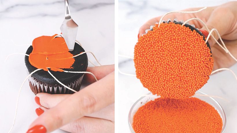 Carefully, I used a palette knife to spread a thin layer of orange buttercream on top, and dipped in nonpareils.