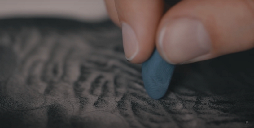 Creating texture of the elephant's skin using a kneadable eraser.