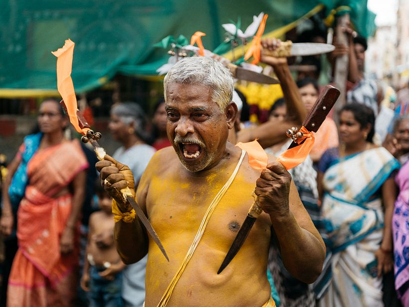 A man displays fierce kathi performance at the ritual