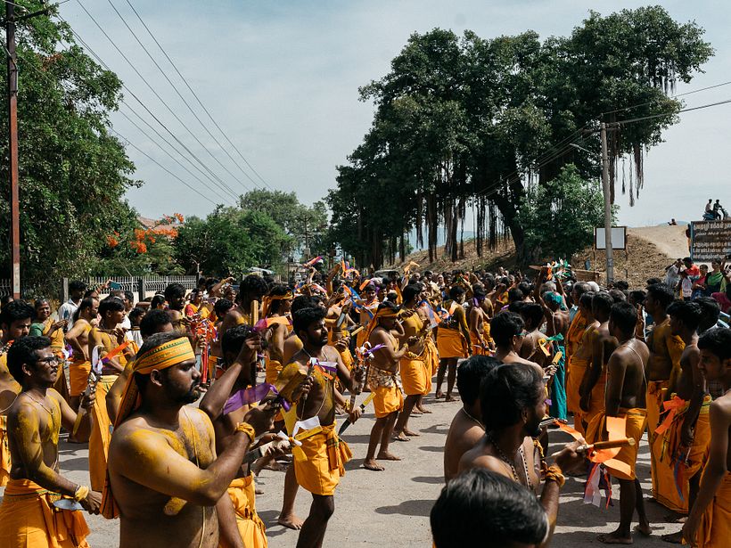 Devotees performing the Kathi ritual by the banks of a lake.