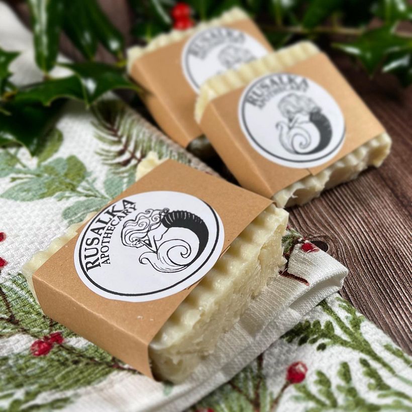 bar of soap wrapped in a brown paper label with a black and white label reading Rusalka Apothecary